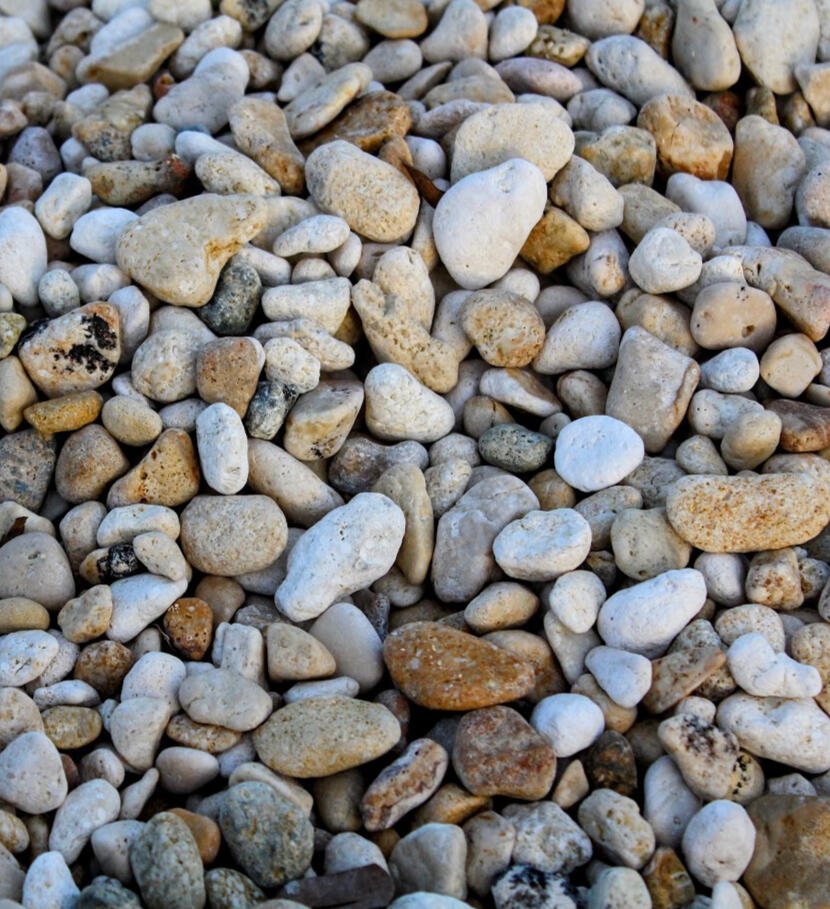 Pebbles used in psychotherapy sessions A photo of mixed pebbles on a beach taken by Rebecca. This photo represents Rebecca's creative expression and how she integrates it in her one-to-one therapy, couple therapy, family therapy and child therapy.